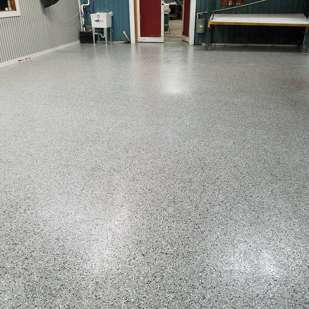Finished gray flake epoxy floor in commercial shop