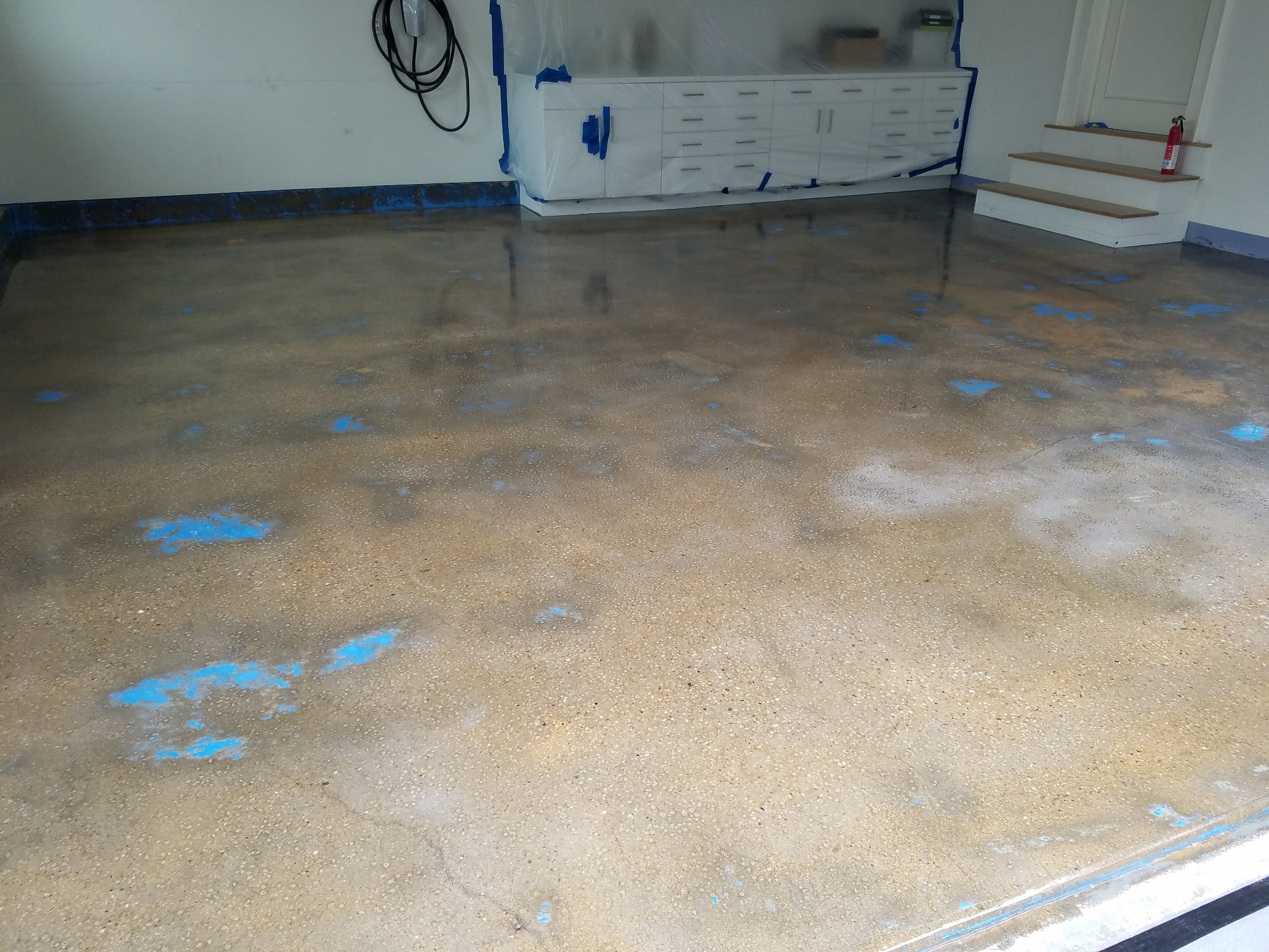 Garage concrete floor patched and prepped for epoxy