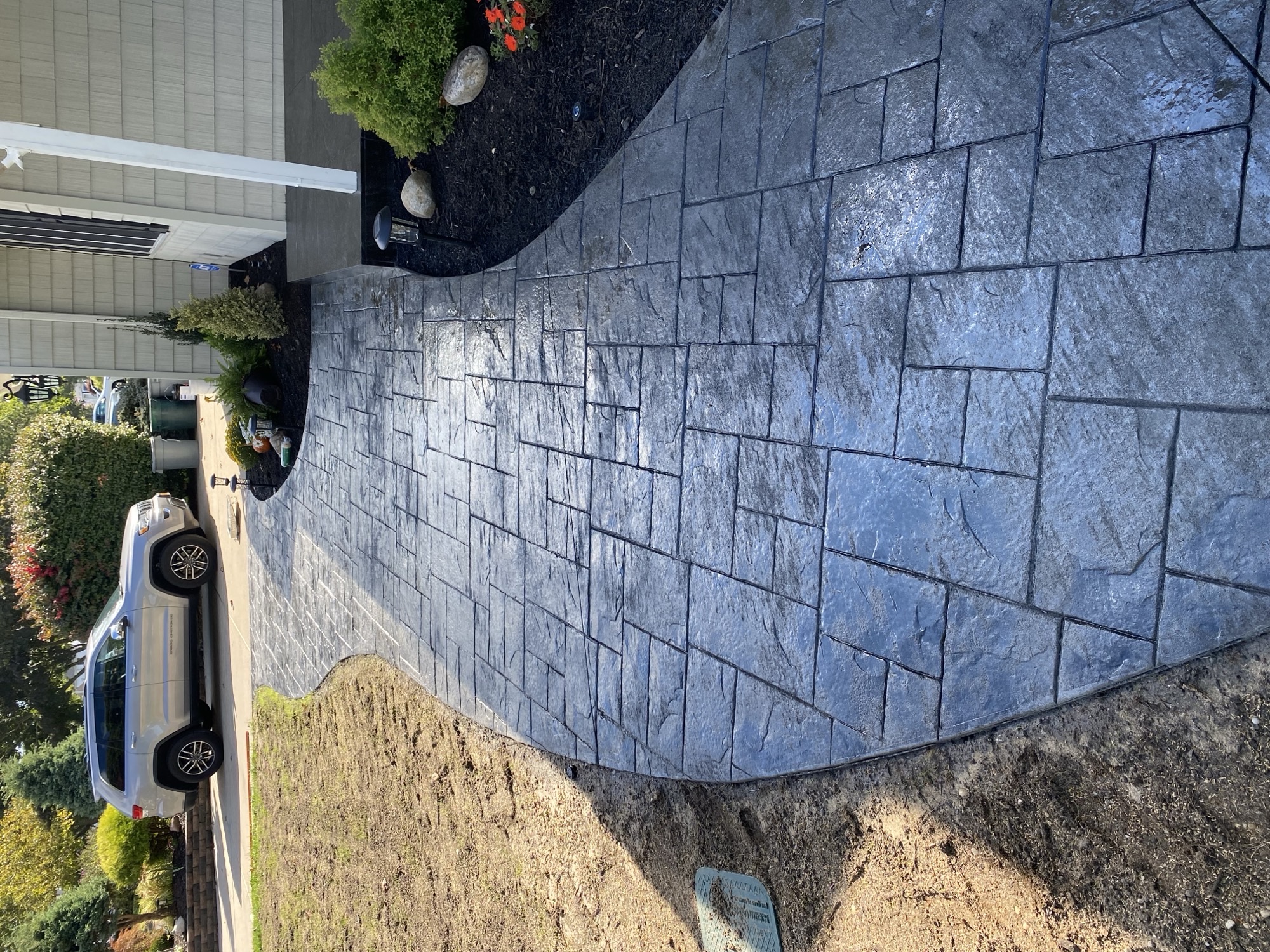 Stamped concrete front walkway with landscape borders