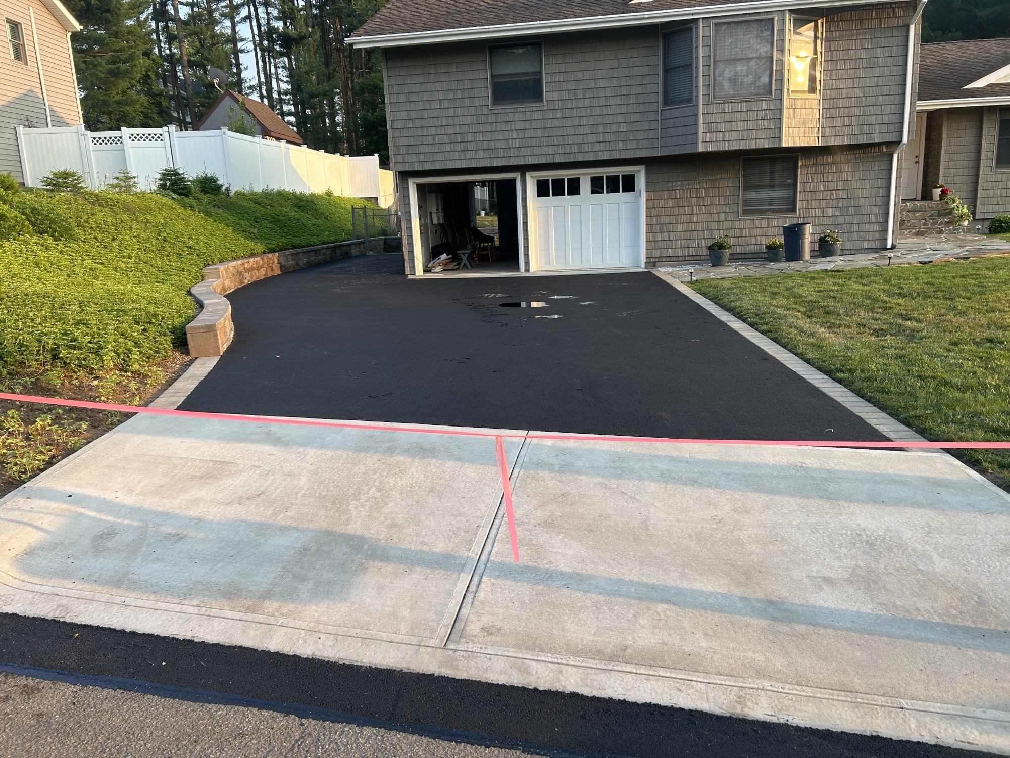 Concrete driveway apron with asphalt drive