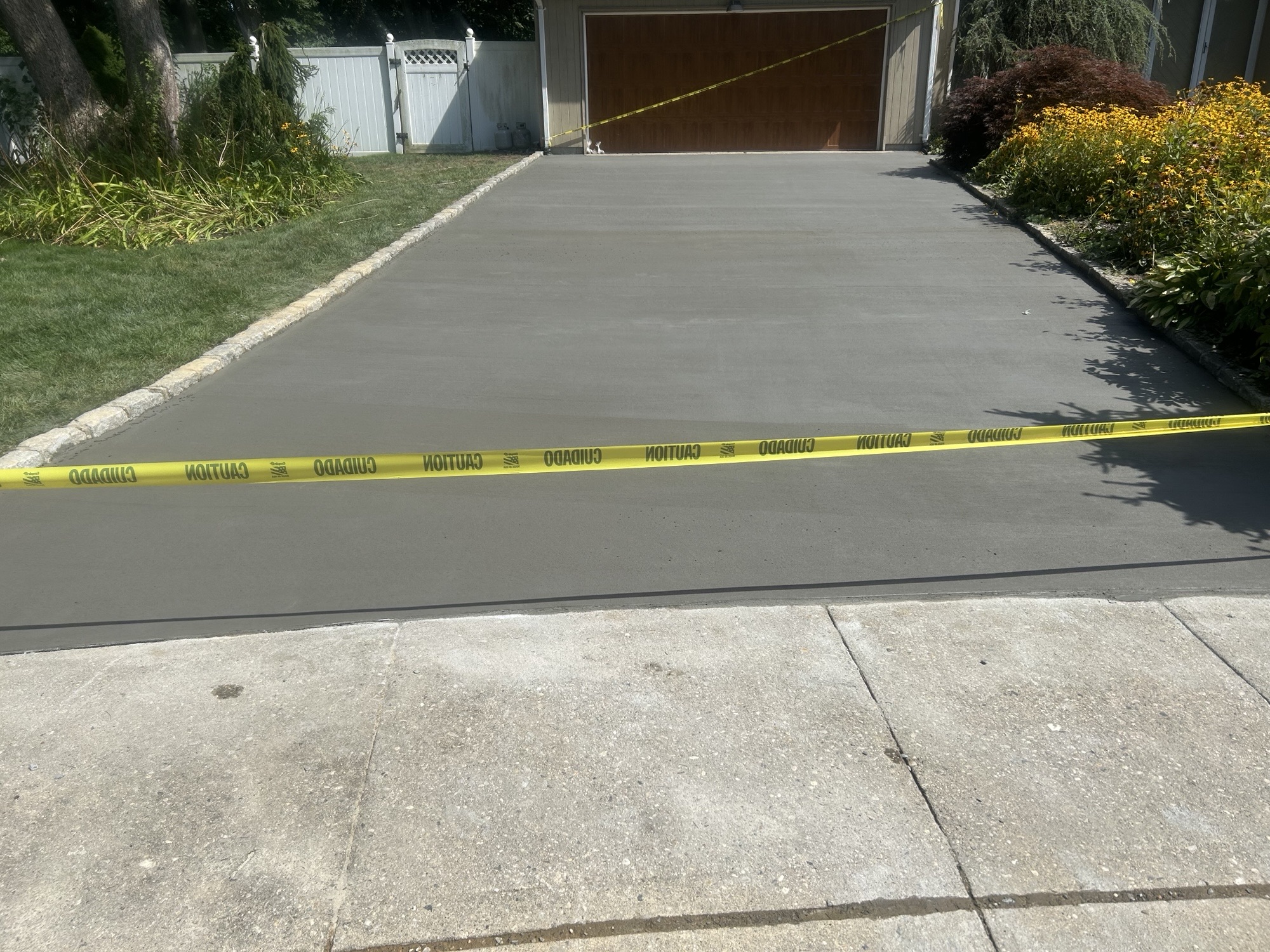 Freshly poured broom-finish concrete driveway