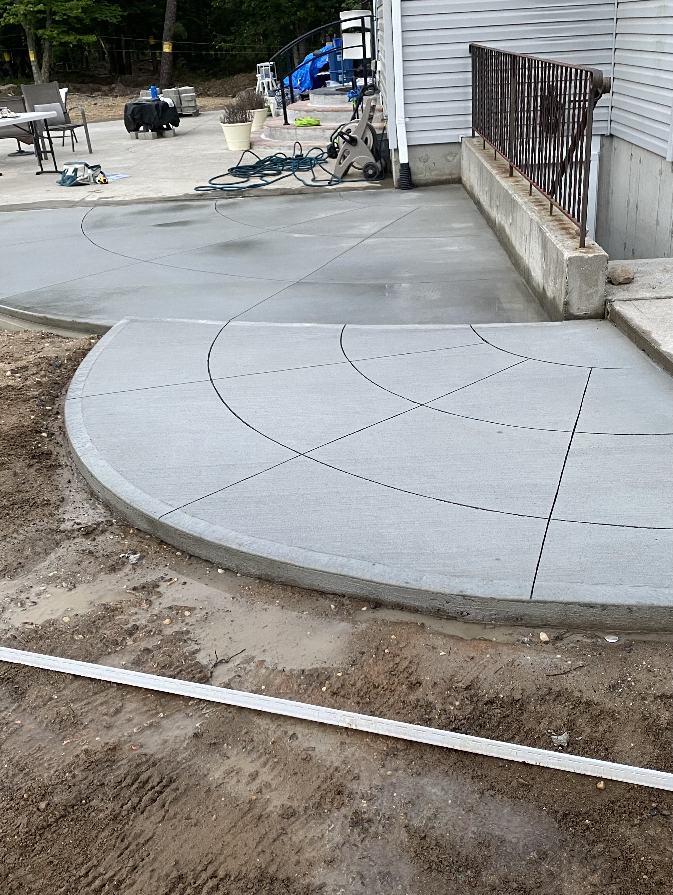 Scored fan-pattern concrete patio extension