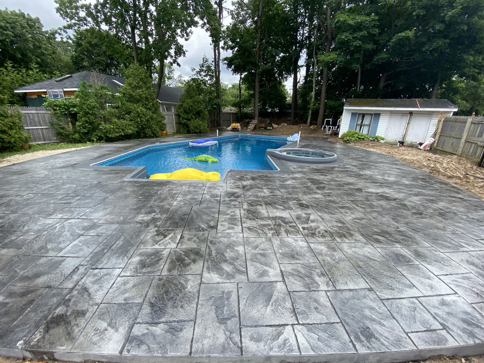 Stamped concrete pool deck with spa surround