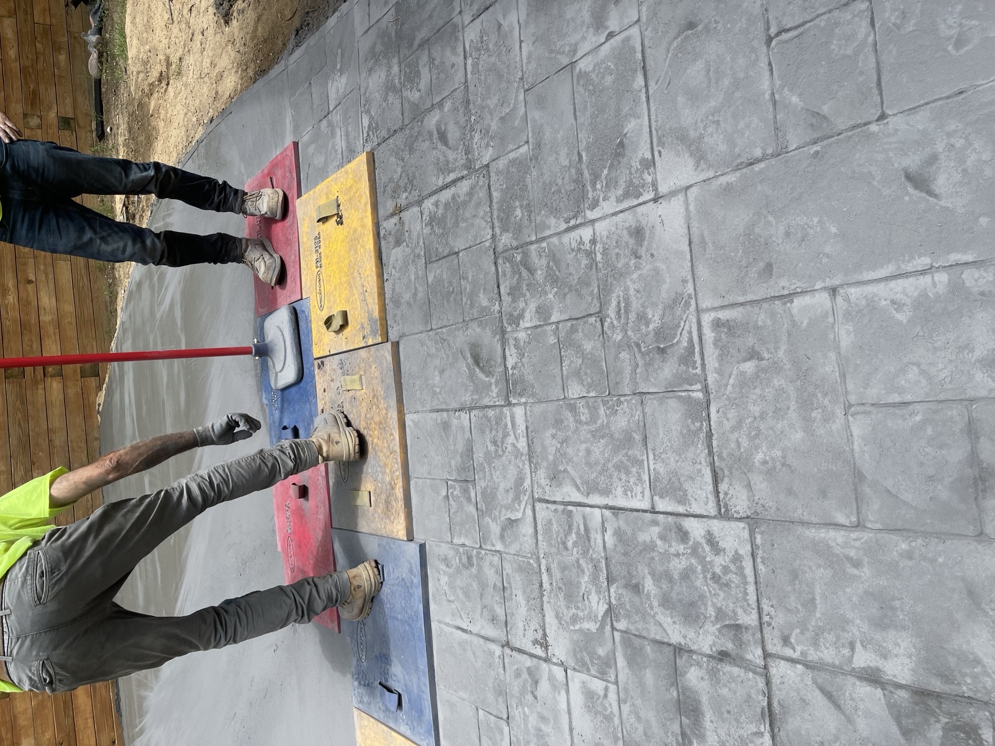 Crew stamping a fresh concrete patio